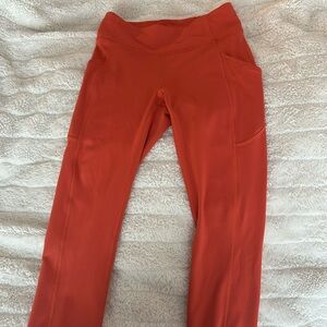Lululemon Orange Aligned Leggings size 6 with size pockets.